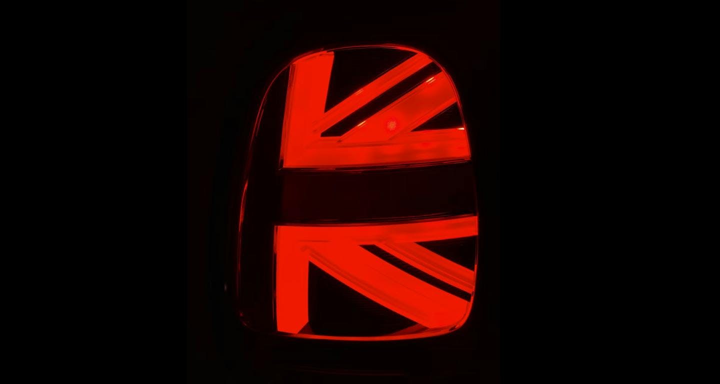 UK flag shown in a wingmirror reflection, red lighting with black background